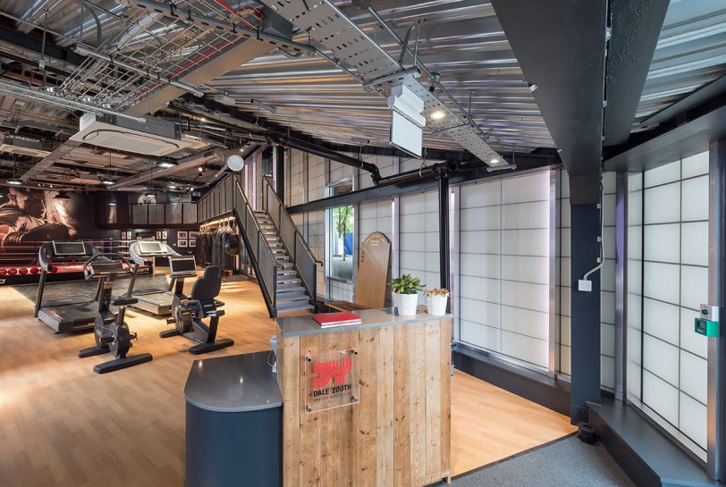 Interior of Dale Youth Amateur Boxing Club featuring front desk and athletic equipment in front of Kalwall wall panel system