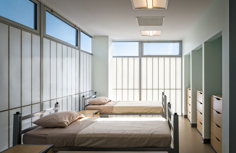 Modern multi-story building called Argus Community featuring large windows highlighting innovative architectural design and energy-efficient translucent glazing solutions by Kalwall.