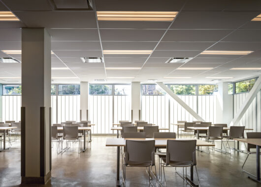 Modern multi-story building called Argus Community featuring large windows highlighting innovative architectural design and energy-efficient translucent glazing solutions by Kalwall.