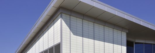 Amtrak station with Kalwall facade featuring unitized panels on one side and brick at base of building.