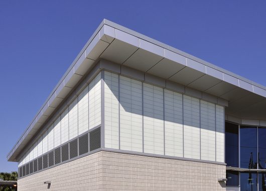 Amtrak station with Kalwall facade featuring unitized panels on one side and brick at base of building.