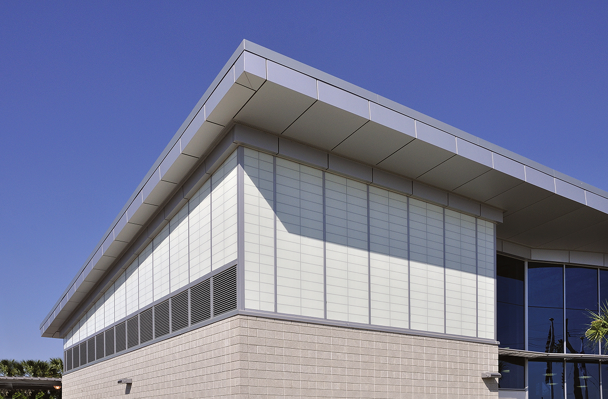 Amtrak station with Kalwall facade featuring unitized panels on one side and brick at base of building.