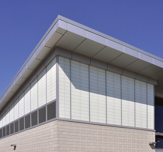 Amtrak station with Kalwall facade featuring unitized panels on one side and brick at base of building.