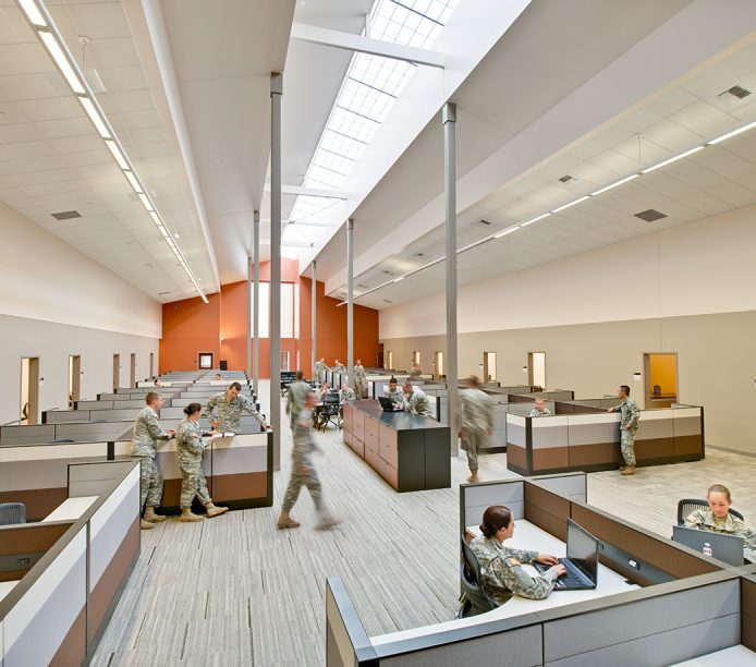 Military facility with orange and white walls and Kalwall skylight system offering translucent daylighting above cubicles