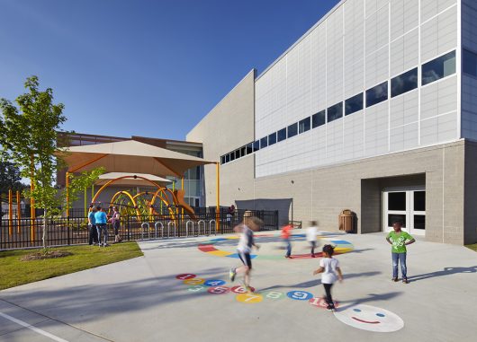 Abbotts Creek Community Center exterior with children playing in front of building clad with Kalwall FRP panel wall system