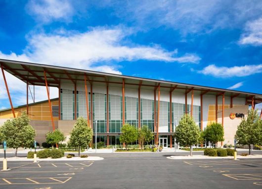 Faith Chapel with multiple sections of Kalwall translucent sandwich panels on building with sloped roof in front of blue sky