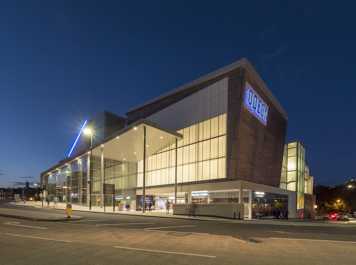 Building exterior at nighttime featuring building clad with Kalwall facade with Odeon written on side.