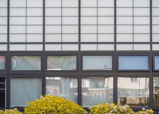 Featherstone High School exterior featuring Kalwall facade application combined with unitized panels for view to outside