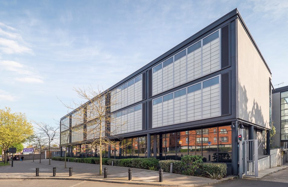 Window replacement by Kalwall on modern-looking Featherstone High School with green trees in front