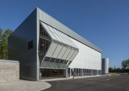 Fermilab exterior shot with unitized curtain wall system with one set of wall panels opening to reveal inside