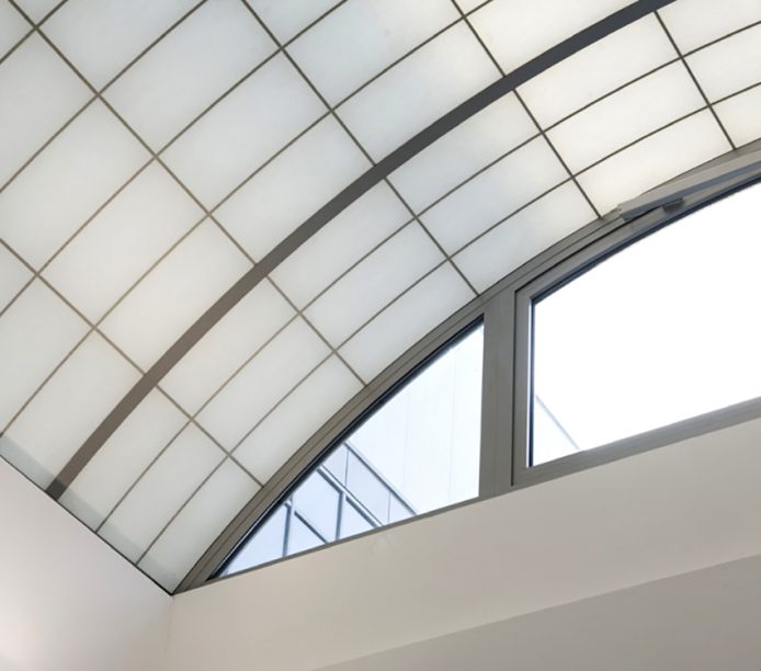 Close-up of Kalwall custom skyroof® with white wall and glass windows