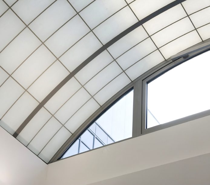 Close-up of Kalwall custom sky roof with white wall and glass windows