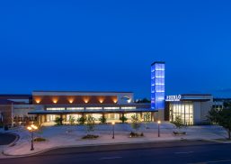 Pueblo Convention Center exterior at nighttime featuring blue backlighting on building tower with Kalwall facade.