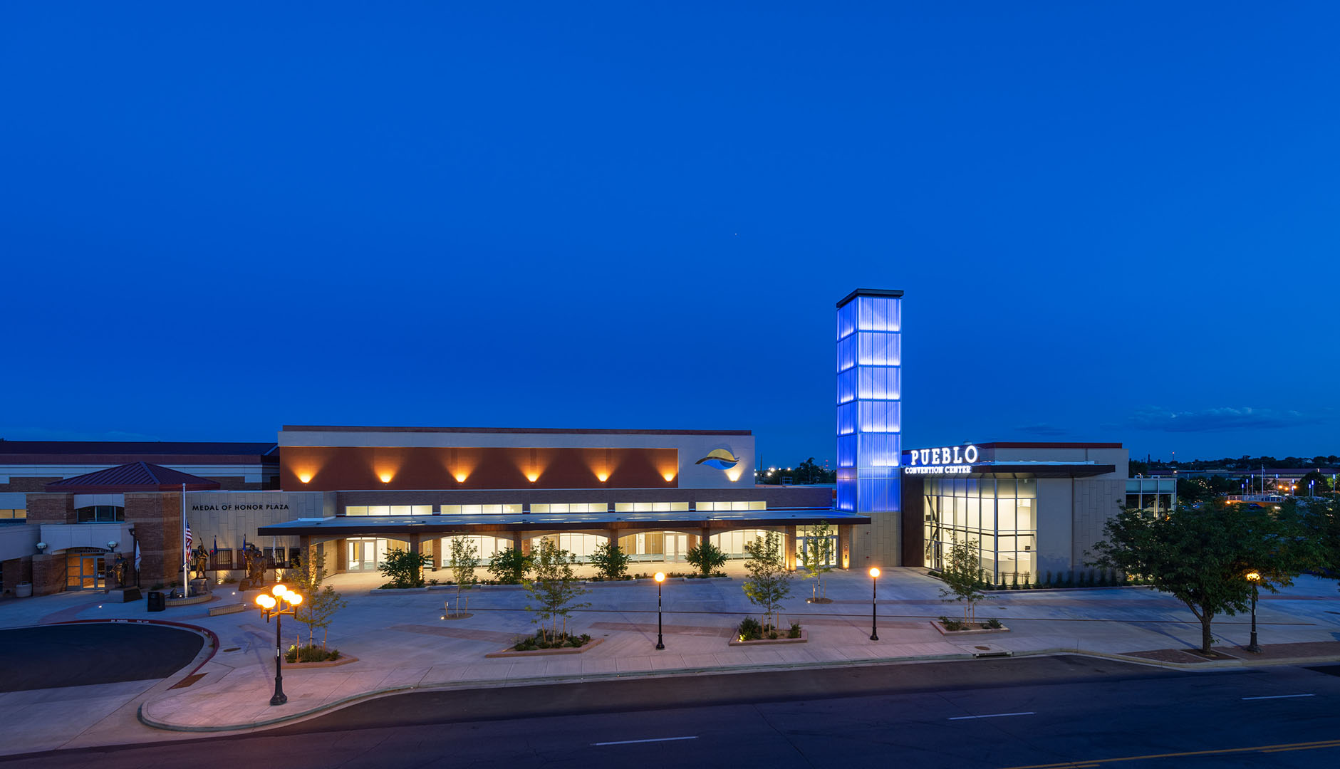 Pueblo Convention Center exterior at nighttime featuring blue backlighting on building tower with Kalwall facade.