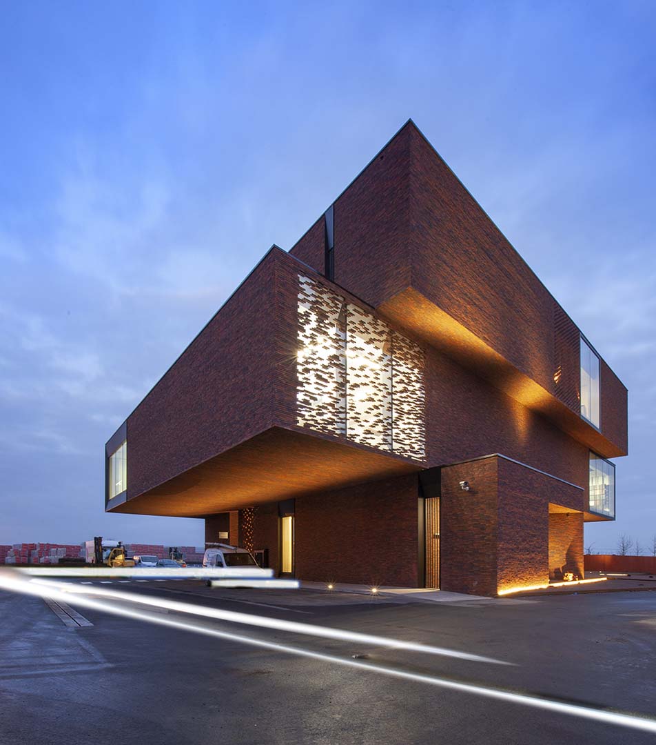 Geometric brick building exterior featuring Kalwall facade section with unique colored panel inserts to look like brick.