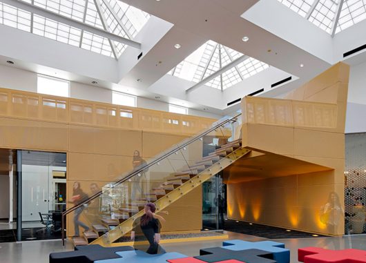 Students walking down staircase at Paradise Valley Community College with overhead lighting from multiple Kalwall skylights