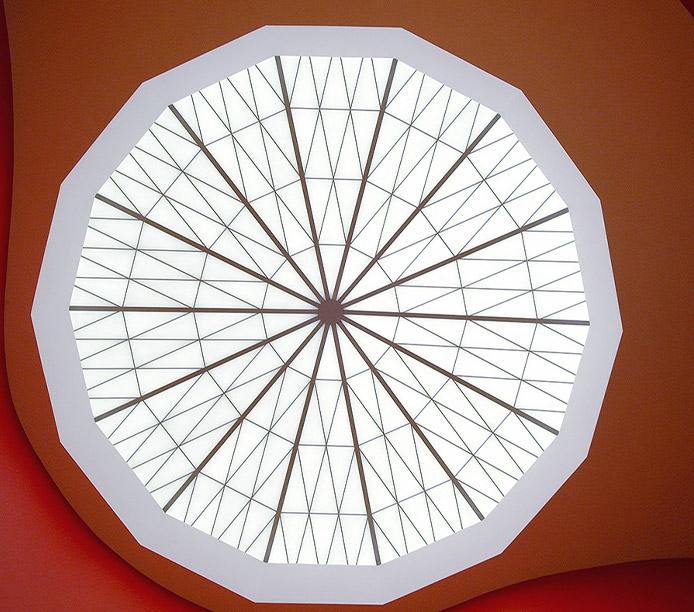 Circular Kalwall geo-roof® custom skylight application provides daylighting through geometric translucent skylight panels surrounded by orange wall