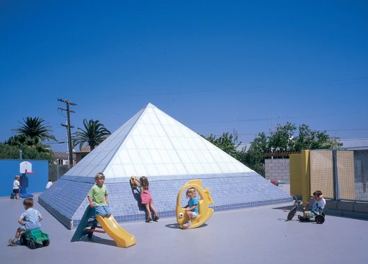 Exterior view of Kalwall skylight at La Marina Preschool surrounded by children playing on various toys
