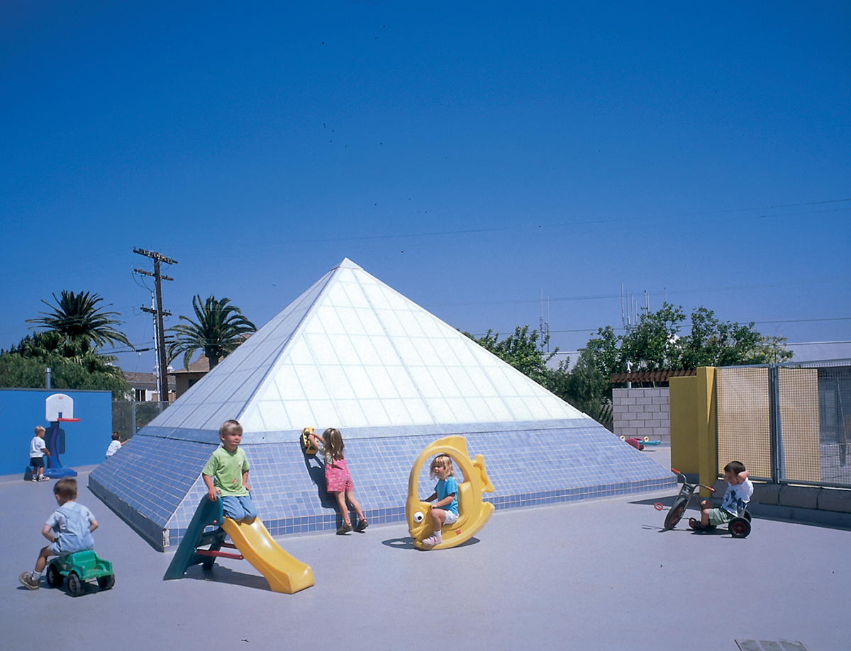 Exterior view of Kalwall skylight at La Marina Preschool surrounded by children playing on various toys