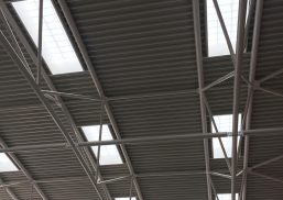 Close-up of Kalwall s-line skylights among metal piping in ceiling featured in the Cheltenham Ladies' College interior.