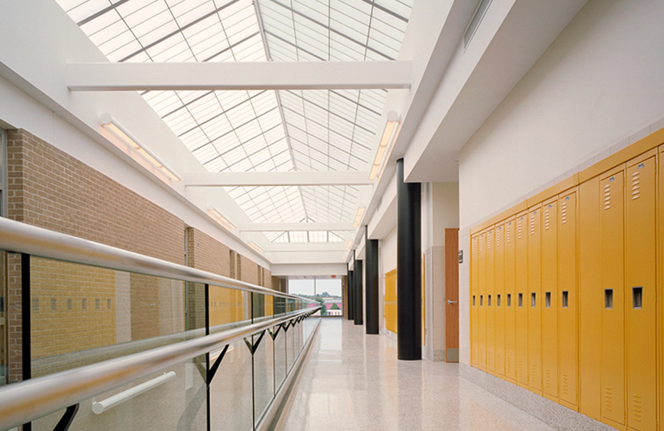 Pre-engineered skyroof® from Kalwall school building featuring yellow lockers and brick wall