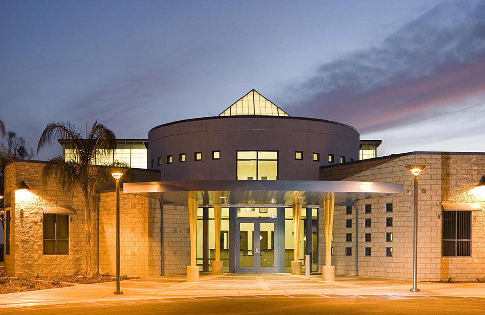 Exterior of brick building featuring circular upper section and a pyramid skylight from Kalwall