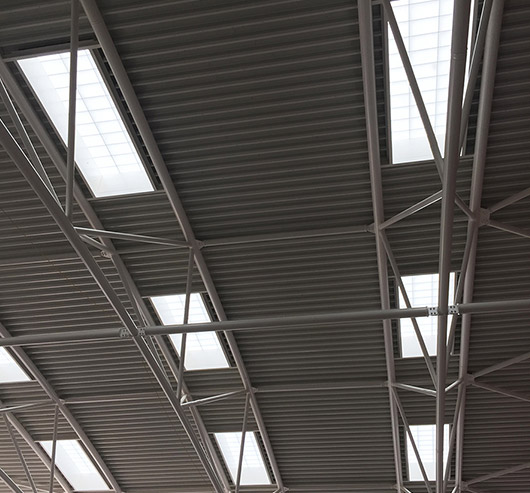 Eight Kalwall skylights applied to white slatted roof with piping