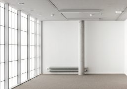 Industrial Design Center at Howest interior of room with white walls, white floor, pole in room and Kalwall facade.