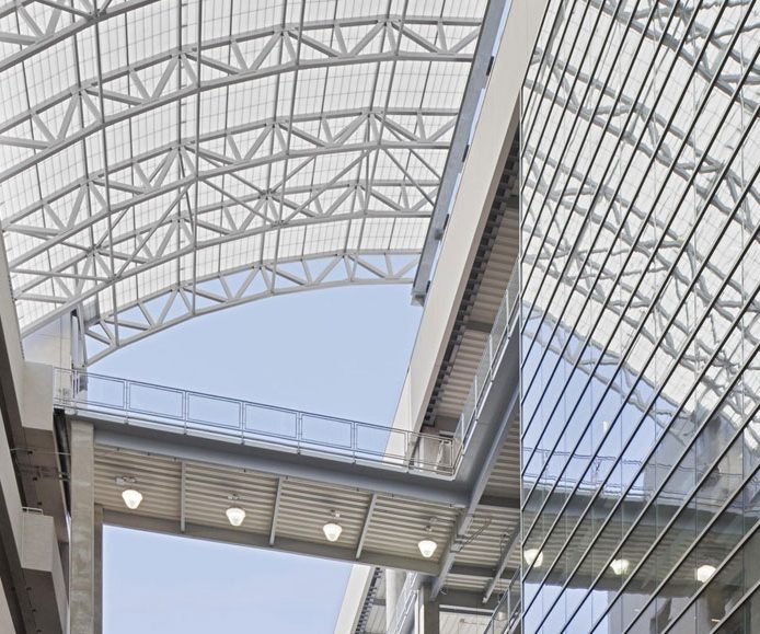 Close-up of East River Plaza shopping center featuring curved Kalwall skyroof® application over walkway connecting buildings