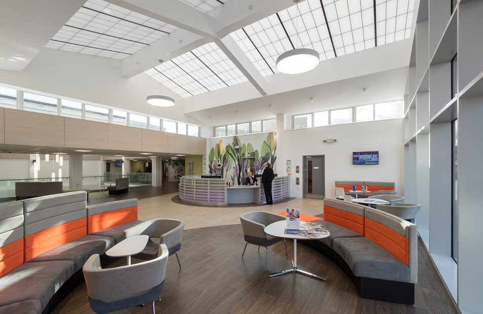 Benenden Hospital atrium and lounge area with tables and chairs featuring skylight windows with Kalwall structural panels