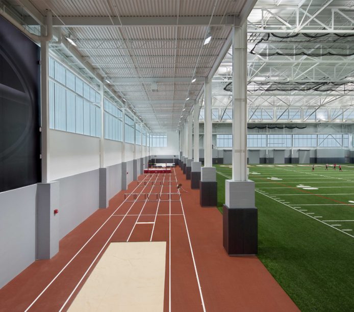 University of Georgia's indoor athletic facility featuring astroturf and running track surrounded by a Kalwall wall system
