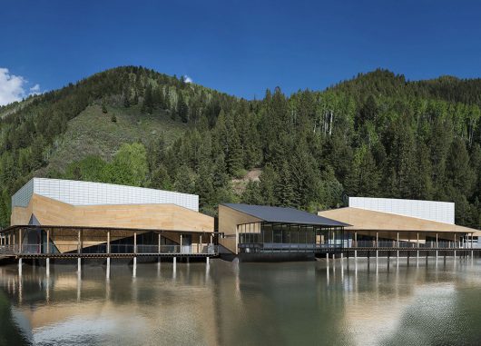 Aspen Music School in front of mountains, blue sky, and lake, featuring Kalwall translucent facade panel wall