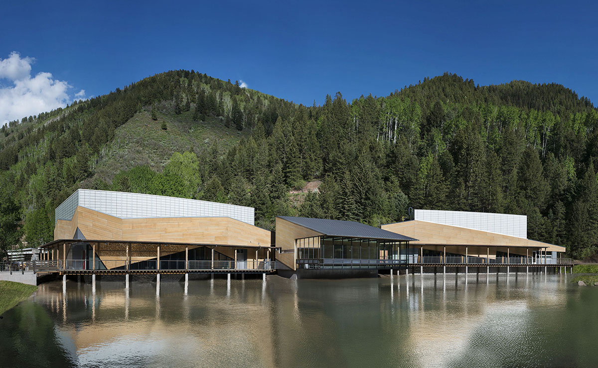 Aspen Music School in front of mountains, blue sky, and lake, featuring Kalwall translucent facade panel wall