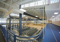 Fitness center at Air Force base featuring workout equipment and blue running track with multiple Kalwall facade systems