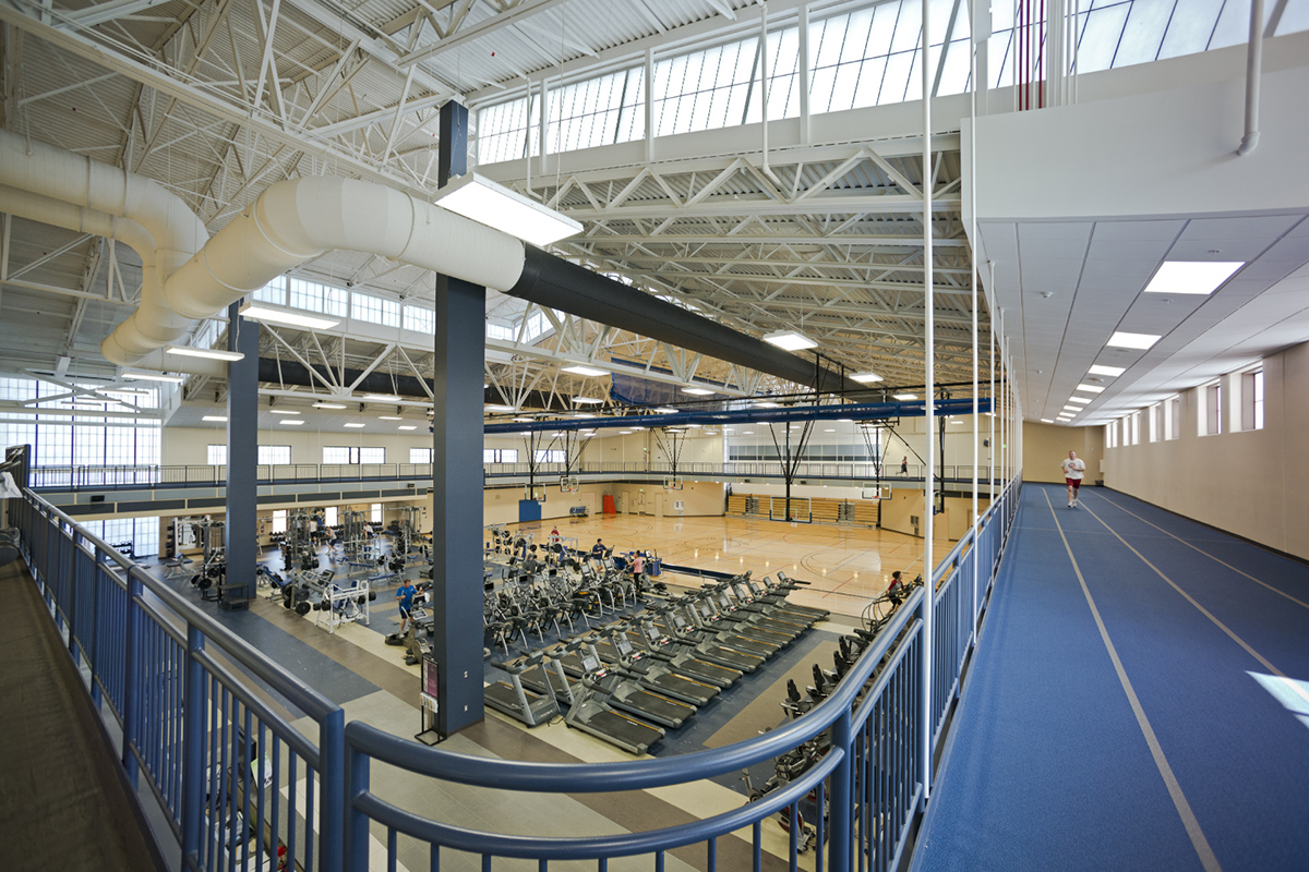 Fitness center at Air Force base featuring workout equipment and blue running track with multiple Kalwall facade systems