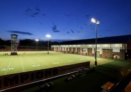 Florida State football practice facility exterior with green field and stadium lights with building with Kalwall FRP panels