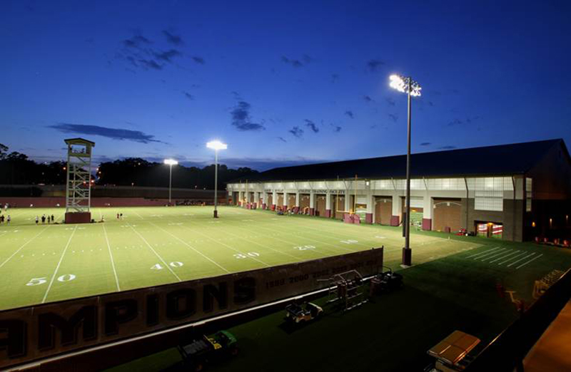 Florida State football practice facility exterior with green field and stadium lights with building with Kalwall FRP panels