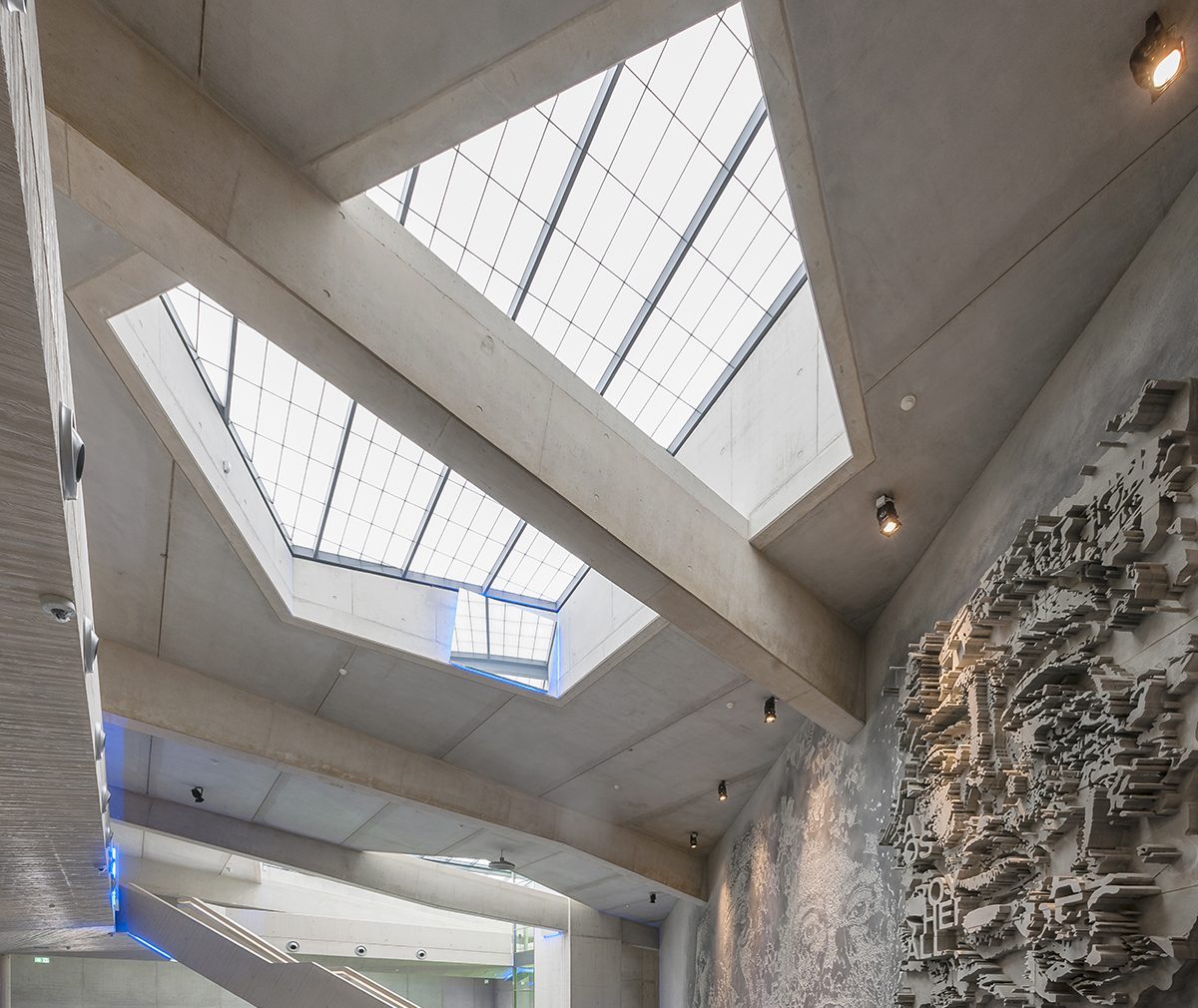 Interior looking up at Kalwall removable skylight with translucent daylighting surrounded by concrete ceiling and beams