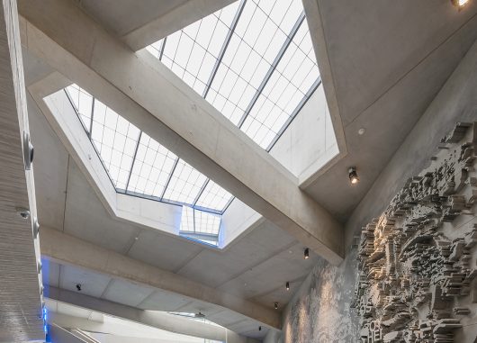 Interior looking up at Kalwall removable skylight with translucent daylighting surrounded by concrete ceiling and beams