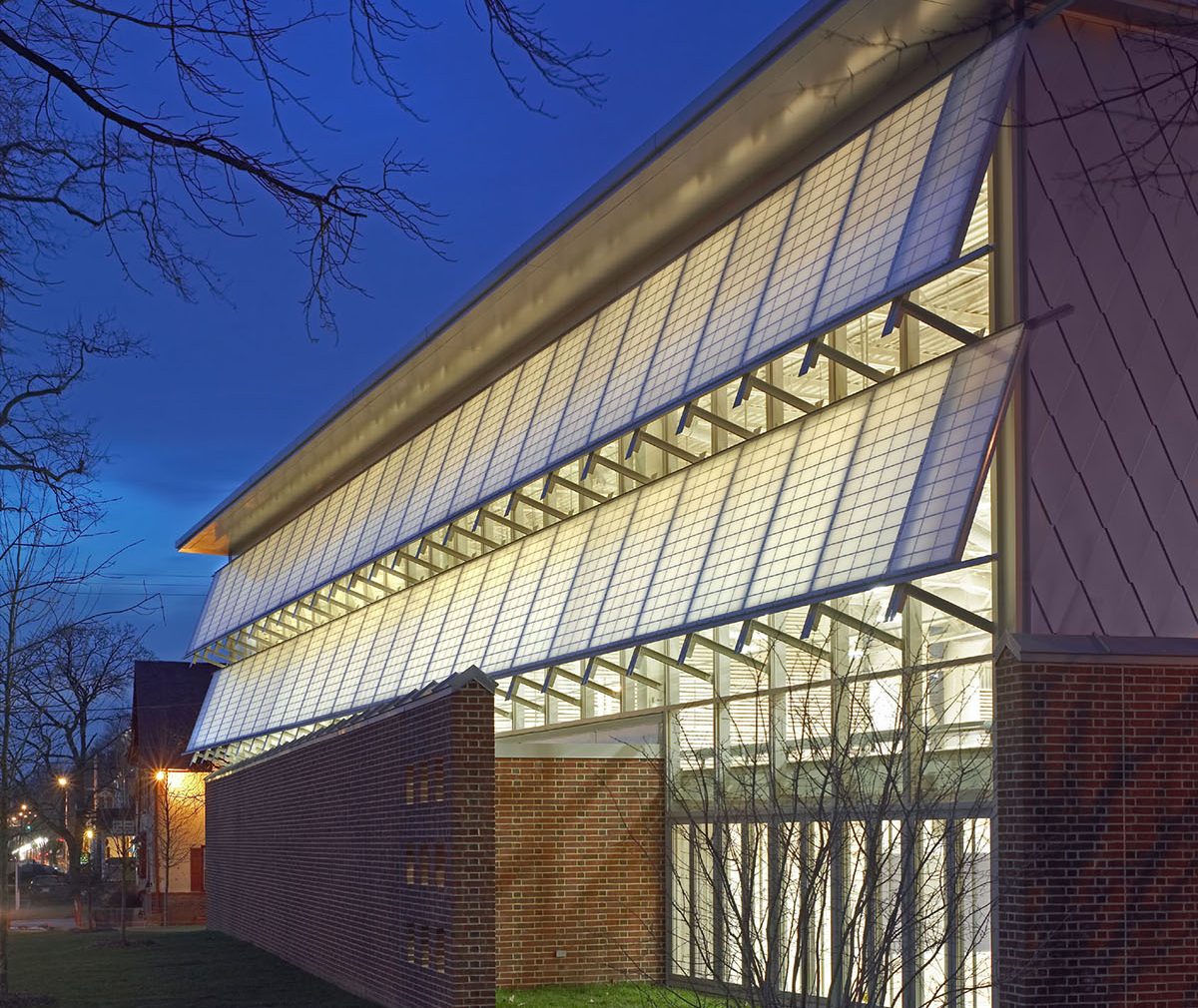 Germantown School exterior at nighttime featuring well-lit Kalwall panels in two canopy sections.