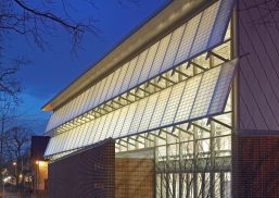 Germantown School exterior at nighttime featuring well-lit Kalwall panels in two canopy sections.