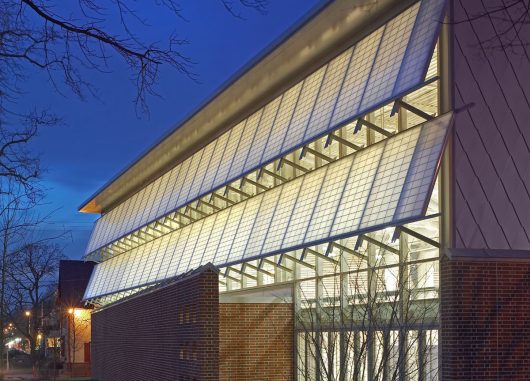 Germantown School exterior at nighttime featuring well-lit Kalwall panels in two canopy sections.