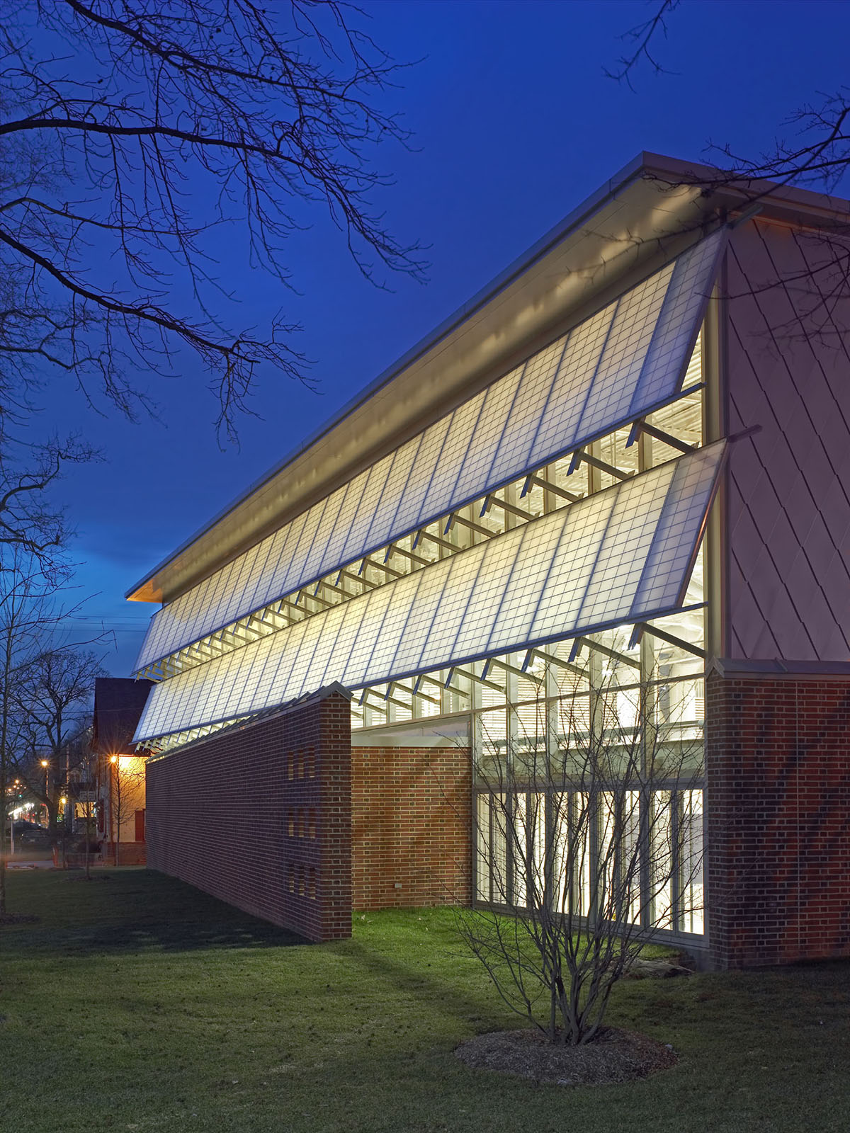 Germantown School exterior at nighttime featuring well-lit Kalwall panels in two canopy sections.