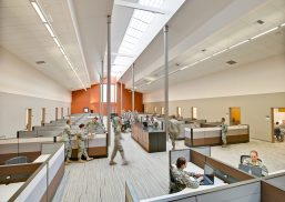 Military facility with orange and white walls and Kalwall skylight system offering translucent daylighting above cubicles