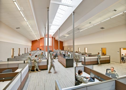 Military facility with orange and white walls and Kalwall skylight system offering translucent daylighting above cubicles