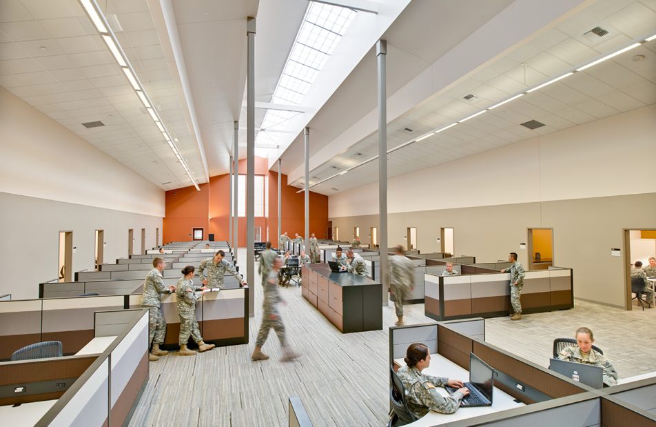 Military facility with orange and white walls and Kalwall skylight system offering translucent daylighting above cubicles