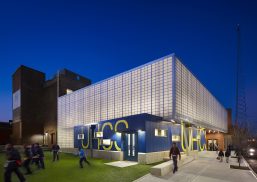 NJ charter school exterior at nighttime with dark blue sky and building of Kalwall curtain wall system with school letters