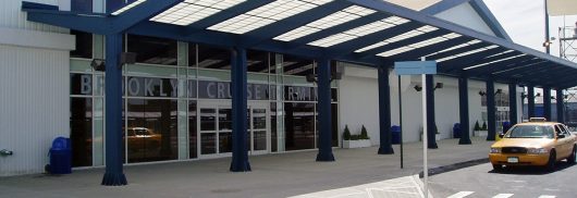 Brooklyn Cruise Terminal building exterior featuring white metal paneling on building and Kalwall translucent canopy system