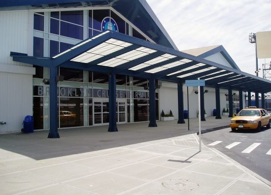 Brooklyn Cruise Terminal building exterior featuring white metal paneling on building and Kalwall translucent canopy system