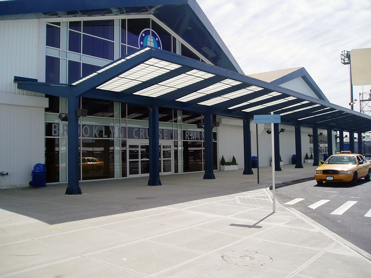 Brooklyn Cruise Terminal building exterior featuring white metal paneling on building and Kalwall translucent canopy system